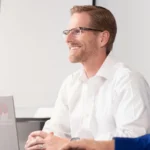man in white business shirt at laptop