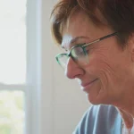 Woman with glasses looking at something